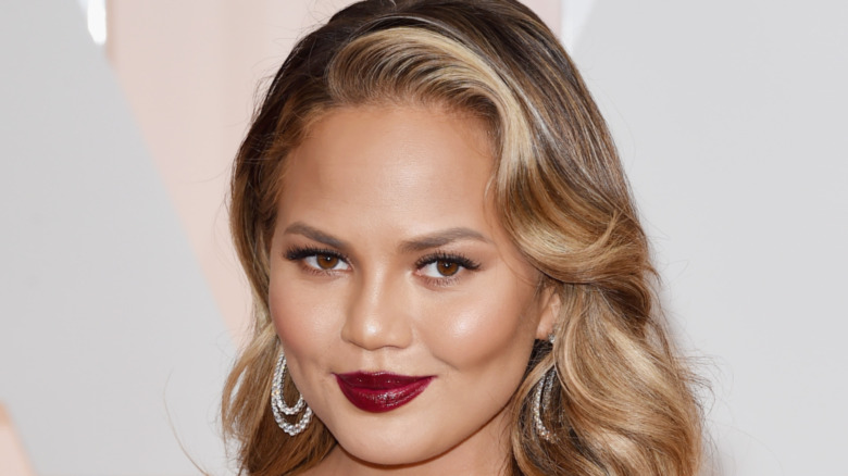 Chrissy Teigen smirking