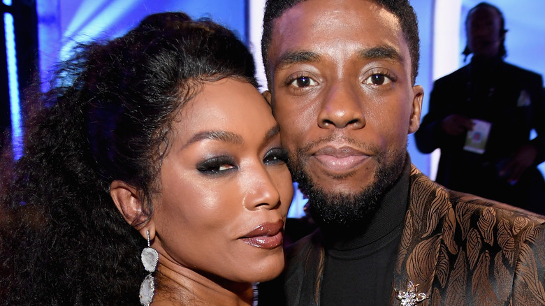 Angela Bassett and Chadwick Boseman posing together