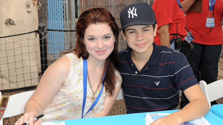 Jennifer Stone and Jake T. Austin posing at autograph signing