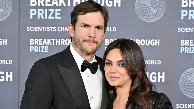 Ashton Kutcher and Mila Kunis posing