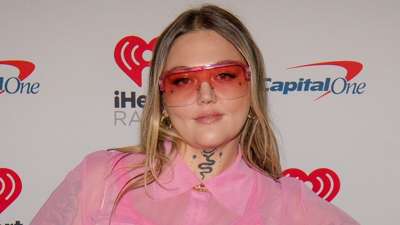 Elle King wearing red glasses