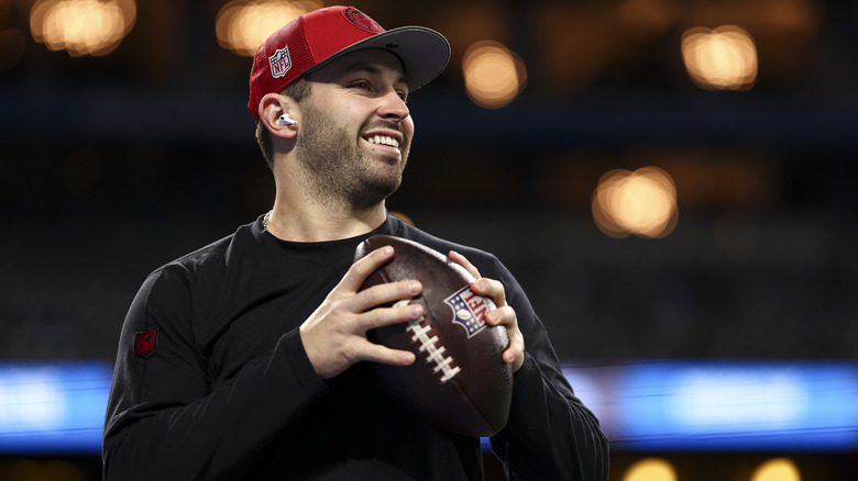 Baker Mayfield stands with football