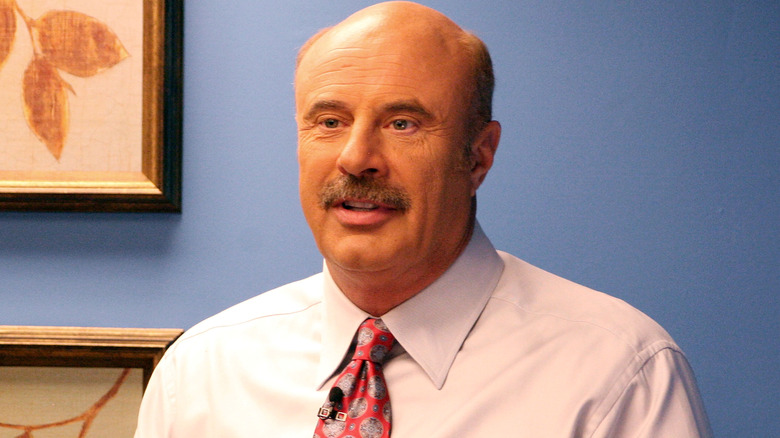 Dr. Phil posing for cameras