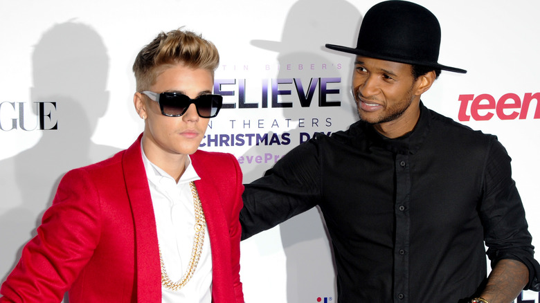 Usher looking at Justin Bieber